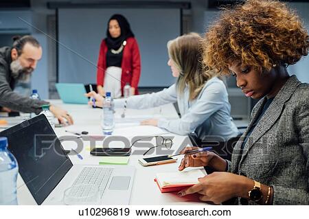 Stock Photo - Business partners at brainstorming meeting in office. Fotosearch