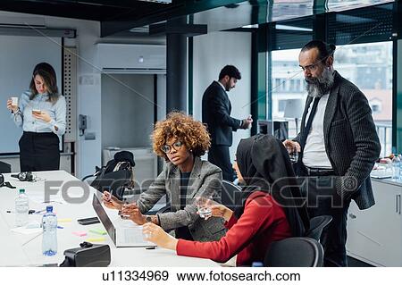 Stock Photo - Business partners at brainstorming meeting in office. Fotosearch