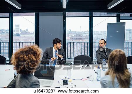 Business partners at brainstorming meeting in office View Large Photo Image Stock Photo - Business partners at brainstorming meeting in office. Fotosearch