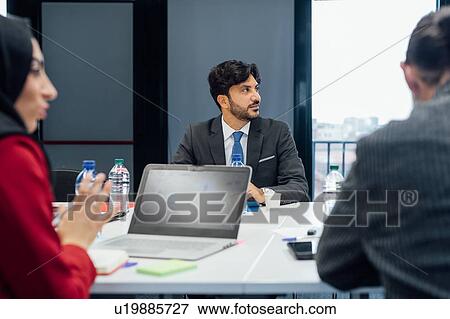 Stock Photo - Business partners at brainstorming meeting in office. Fotosearch