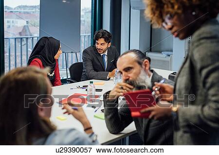 Stock Photo - Business partners at brainstorming meeting in office. Fotosearch