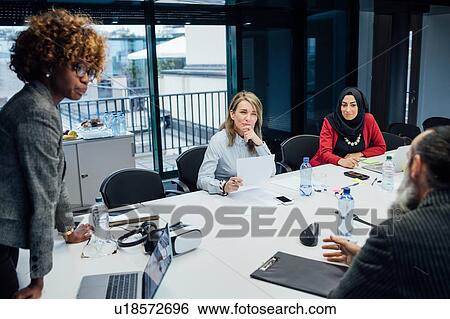 Business partners at brainstorming meeting in office View Large Photo Image Stock Photograph - Business partners at brainstorming meeting in office. Fotosearch