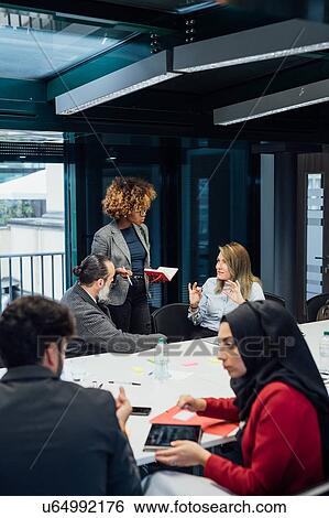 Business partners at brainstorming meeting in office View Large Photo Image Stock Photograph - Business partners at brainstorming meeting in office. Fotosearch