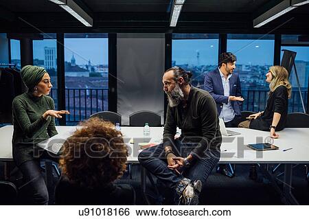 Business partners at brainstorming meeting in office View Large Photo Image Stock Photograph - Business partners at brainstorming meeting in office. Fotosearch
