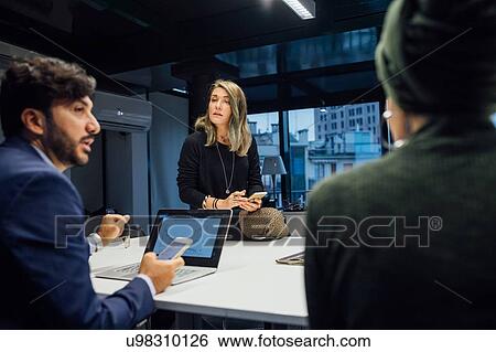 Stock Photograph - Business partners at brainstorming meeting in office. Fotosearch
