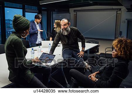 Business partners at brainstorming meeting in office View Large Photo Image Stock Photography - Business partners at brainstorming meeting in office. Fotosearch