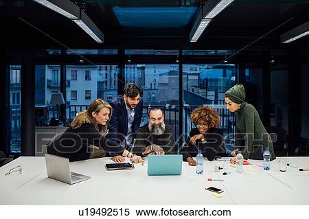 Business partners at brainstorming meeting in office View Large Photo Image Stock Photography - Business partners at brainstorming meeting in office. Fotosearch