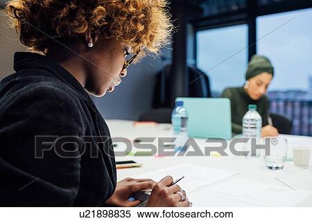Business partners at meeting in office View Large Photo Image Stock Photography - Business partners at meeting in office. Fotosearch