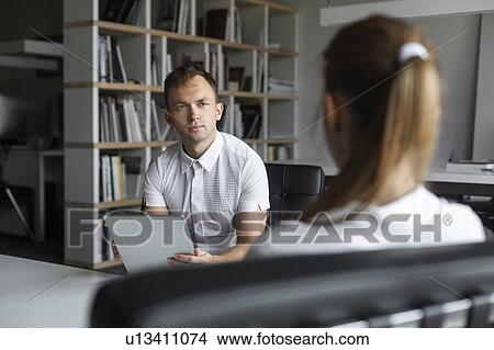 Businessman conducting job interview with young woman View Large Photo Image Picture - Businessman conducting job interview with young woman. Fotosearch