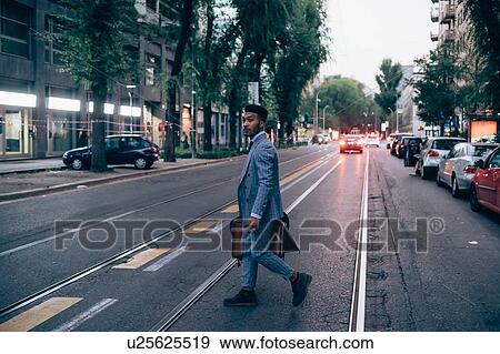 Businessman crossing road, Milano, Lombardia, Italy View Large Photo Image Stock Photo - Businessman crossing road, Milano, Lombardia, Italy. Fotosearch