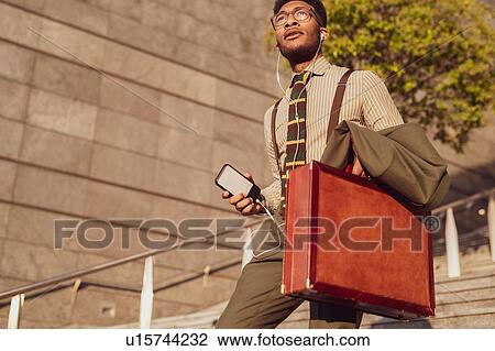 Businessman descending stairs of office building, Milano, Lombardia, Italy View Large Photo Image Stock Image - Businessman descending stairs of office building, Milano, Lombardia, Italy. Fotosearch