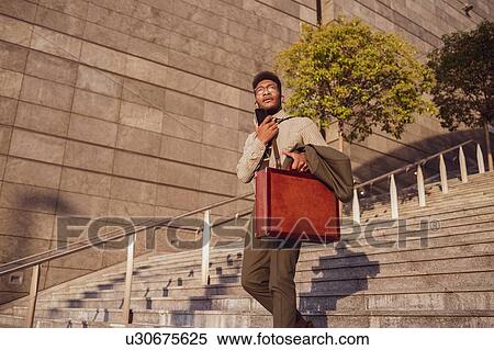 Businessman descending stairs of office building, Milano, Lombardia, Italy View Large Photo Image Stock Photography - Businessman descending stairs of office building, Milano, Lombardia, Italy. Fotosearch