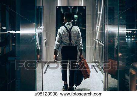 Businessman entering elevator View Large Photo Image Stock Photo - Businessman entering elevator. Fotosearch