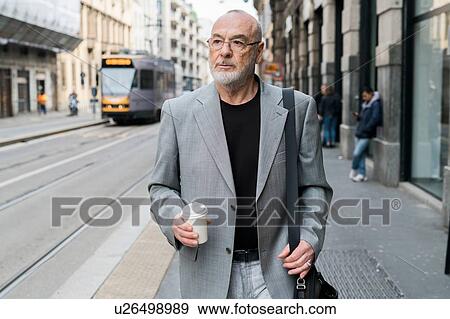 Stock Photo - Businessman in city, Milan, Lombardia, Italy. Fotosearch