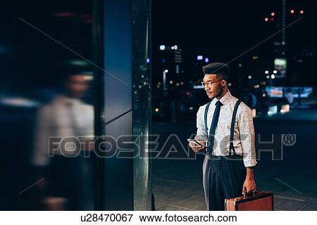 Businessman looking into window of shop View Large Photo Image Stock Photo - Businessman looking into window of shop. Fotosearch