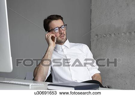 Stock Image - Businessman talking on phone. Fotosearch