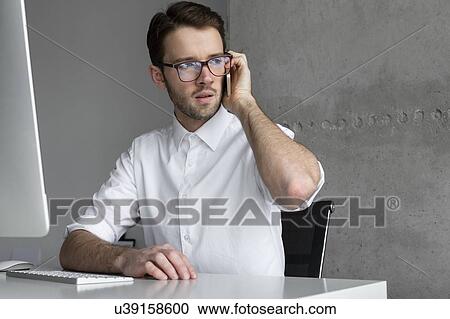 Stock Image - Businessman talking on phone. Fotosearch