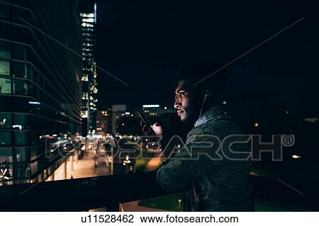 Businessman using smartphone on balcony, Milano, Lombardia, Italy View Large Photo Image Stock Image - Businessman using smartphone on balcony, Milano, Lombardia, Italy. Fotosearch