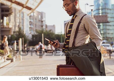 Businessman using smartphone on pavement, Milano, Lombardia, Italy View Large Photo Image Stock Image - Businessman using smartphone on pavement, Milano, Lombardia, Italy. Fotosearch
