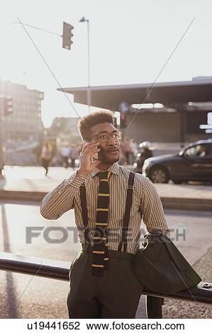 Businessman using smartphone on pavement, Milano, Lombardia, Italy View Large Photo Image Stock Image - Businessman using smartphone on pavement, Milano, Lombardia, Italy. Fotosearch