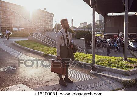 Businessman waiting by pedestrian crossing, Milano, Lombardia, Italy View Large Photo Image Stock Image - Businessman waiting by pedestrian crossing, Milano, Lombardia, Italy. Fotosearch