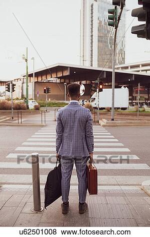 Businessman waiting by pedestrian crossing, Milano, Lombardia, Italy View Large Photo Image Stock Photo - Businessman waiting by pedestrian crossing, Milano, Lombardia, Italy. Fotosearch