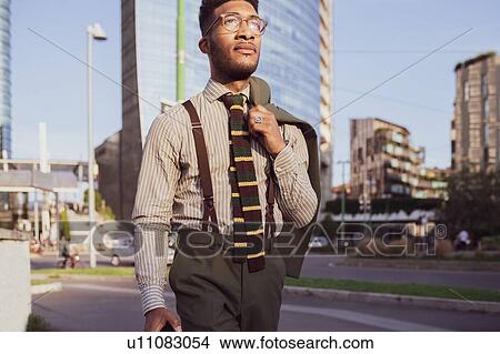 Picture - Businessman walking in city, Milano, Lombardia, Italy. Fotosearch