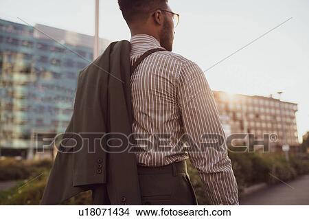 Picture - Businessman walking in city, Milano, Lombardia, Italy. Fotosearch