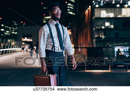 Picture - Businessman walking in city, Milano, Lombardia, Italy. Fotosearch