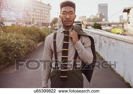 Stock Image - Businessman walking in city, Milano, Lombardia, Italy. Fotosearch