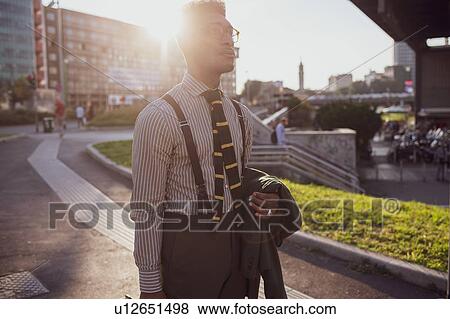 Stock Photo - Businessman walking in city, Milano, Lombardia, Italy. Fotosearch
