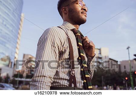 Stock Photo - Businessman walking in city, Milano, Lombardia, Italy. Fotosearch