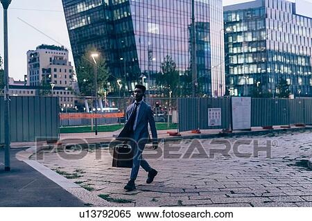 Businessman walking in city, Milano, Lombardia, Italy View Large Photo Image Stock Photography - Businessman walking in city, Milano, Lombardia, Italy. Fotosearch