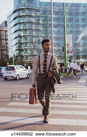 Businessman walking on pedestrian crossing, Milano, Lombardia, Italy View Large Photo Image Stock Image - Businessman walking on pedestrian crossing, Milano, Lombardia, Italy. Fotosearch