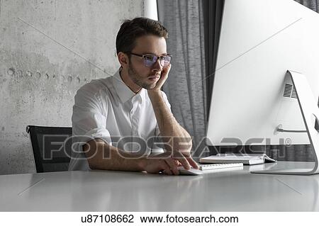 Businessman working at computer View Large Photo Image Stock Image - Businessman working at computer. Fotosearch