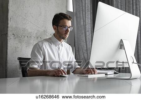 Stock Photograph - Businessman working at computer. Fotosearch