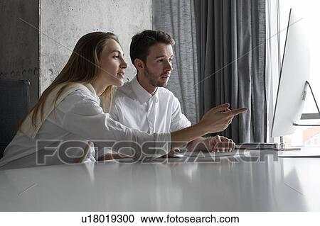 Businesspeople using computer together View Large Photo Image Stock Image - Businesspeople using computer together. Fotosearch