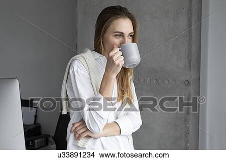 Picture - Businesswoman drinking coffee. Fotosearch