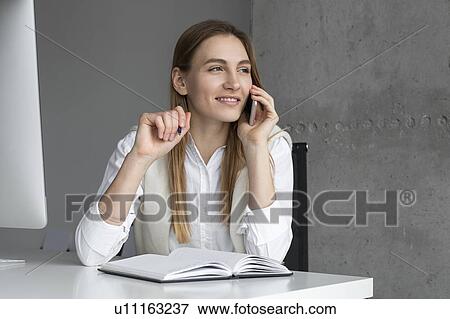 Stock Photo - Businesswoman talking on phone. Fotosearch