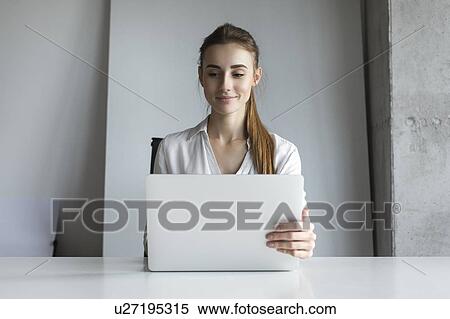 Businesswoman working on laptop View Large Photo Image Stock Photography - Businesswoman working on laptop. Fotosearch