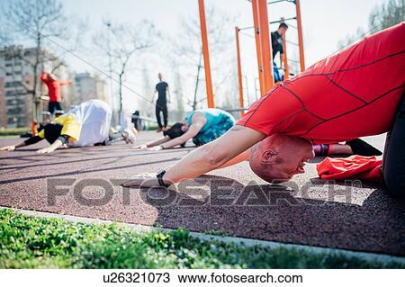 Calisthenics class at outdoor gym, man and women practicing yoga position View Large Photo Image Stock Image - Calisthenics class at outdoor gym, man and women practicing yoga position. Fotosearch