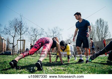 Calisthenics class at outdoor gym, instructor supporting women practicing yoga View Large Photo Image Stock Image - Calisthenics class at outdoor gym, instructor supporting women practicing yoga. Fotosearch