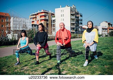 Calisthenics class at outdoor gym, young women and man practicing warrior yoga position View Large Photo Image Stock Photograph - Calisthenics class at outdoor gym, young women and man practicing warrior yoga position. Fotosearch