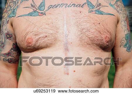Stock Photo - Calisthenics in park, bare chested tattooed mature man, close up. Fotosearch
