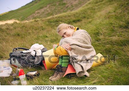 Picture - Camping woman wrapped in blanket. Fotosearch