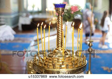 Stock Photo - Candle holder in church during wedding. Fotosearch