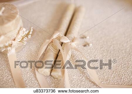 Candles tied by ribbon during wedding View Large Photo Image Stock Photograph - Candles tied by ribbon during wedding. Fotosearch