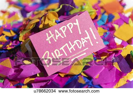 Card reading 'Happy Birthday! ' on pile on confetti View Large Photo Image Picture - Card reading 'Happy Birthday! ' on pile on confetti. Fotosearch