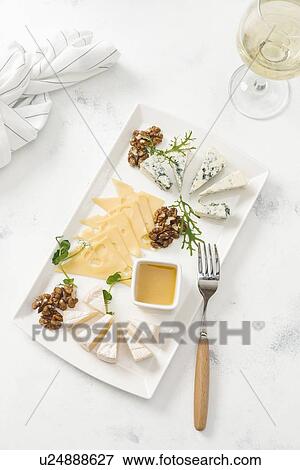 Cheese plate by glass of white wine View Large Photo Image Stock Photo - Cheese plate by glass of white wine. Fotosearch