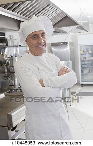 Chef smiling in commercial kitchen View Large Photo Image Stock Image - Chef smiling in commercial kitchen. Fotosearch